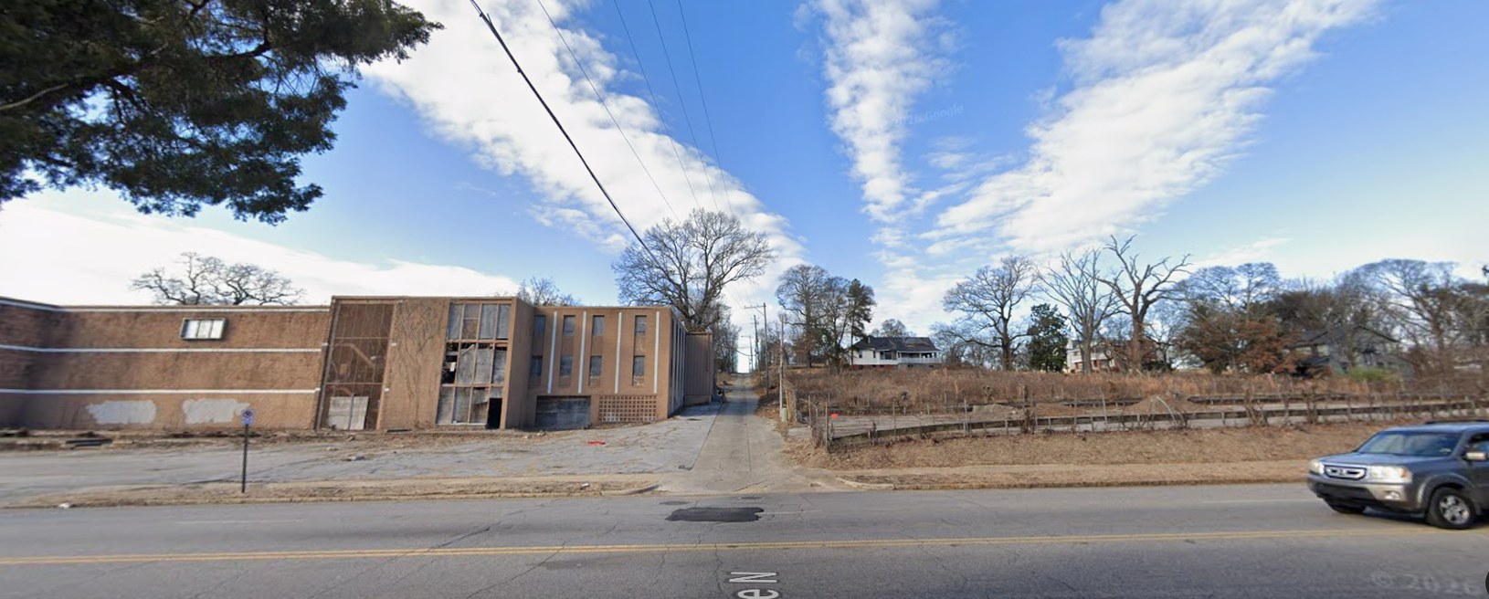 Before: a vacant Northside commercial building restored as mixed-use storefronts with apartments above