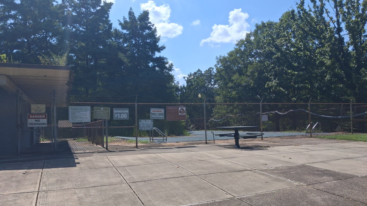 Before: the locked front gate of the closed Norwood pool, reopened with the water full and children swimming
